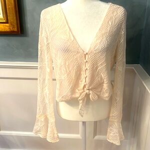 Sexy cream colored lace top by Wayf with knotted tie at waist.